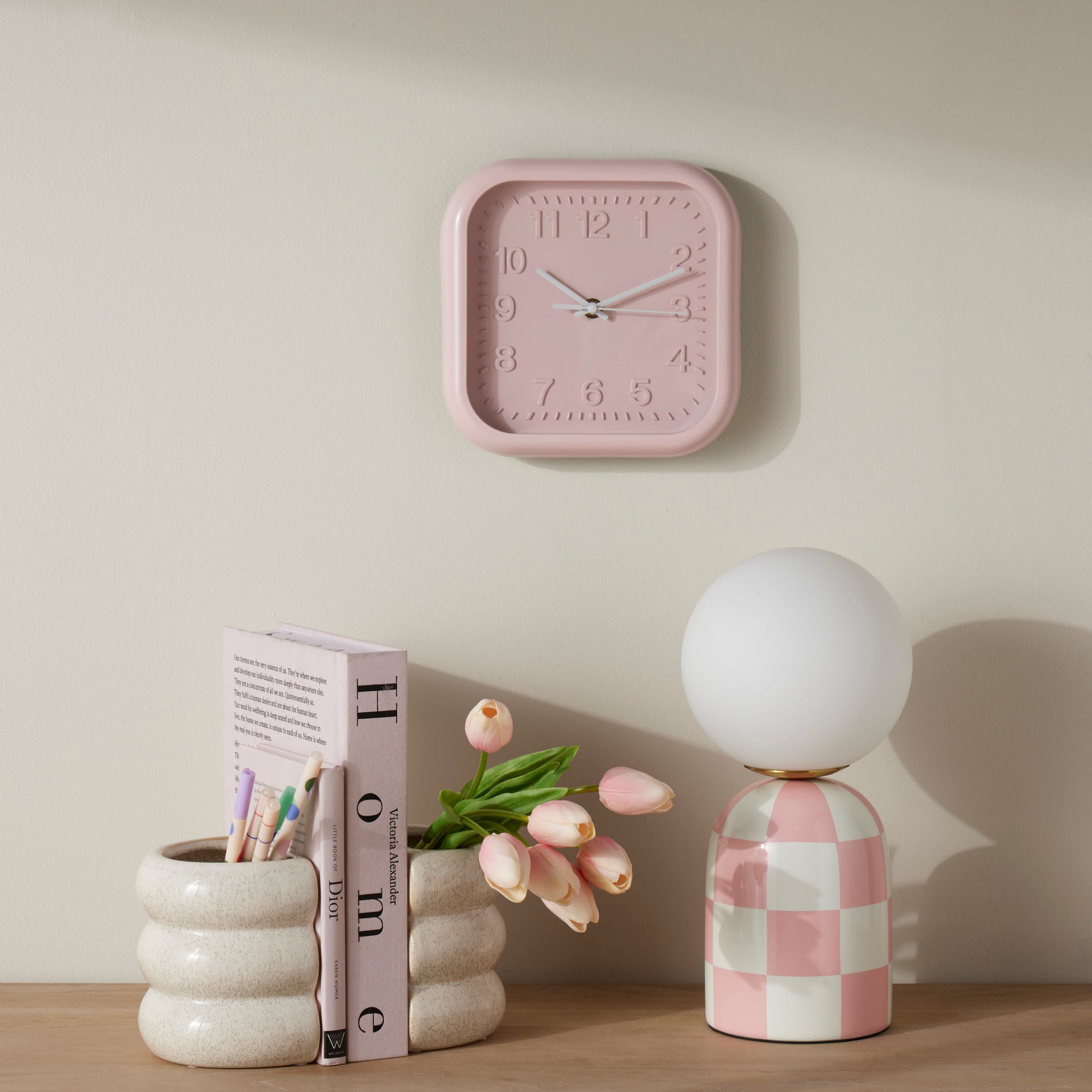 Archie pink and white table lamp styled on a timber console