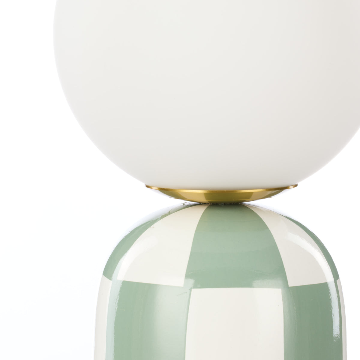Close-up of Archie green and white table lamp glass shade and ceramic base