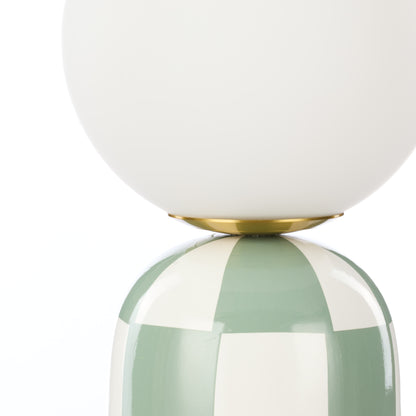 Close-up of Archie green and white table lamp glass shade and ceramic base